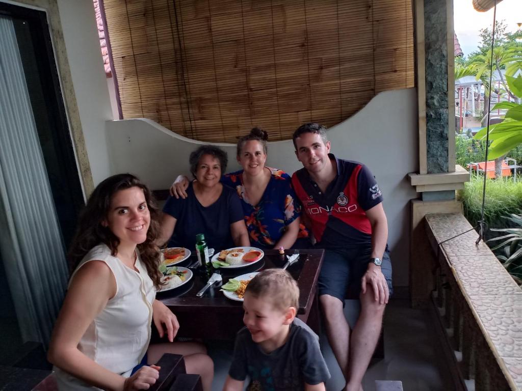 a group of people sitting at a table at Solaluna Beach Homestay in Amed