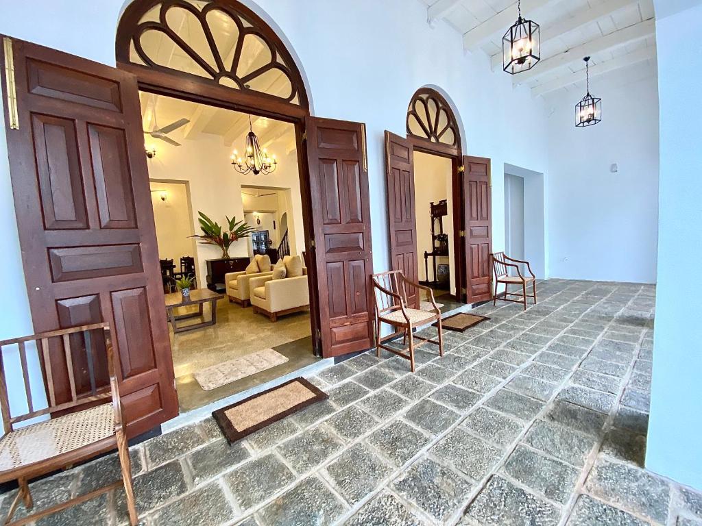 a large room with doors and a living room at Arches Fort in Galle