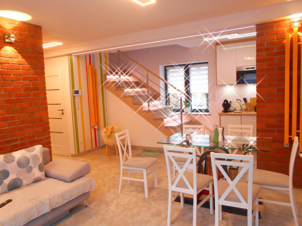 a kitchen and living room with a staircase in a house at Apartament Huzar in Krynica Zdrój
