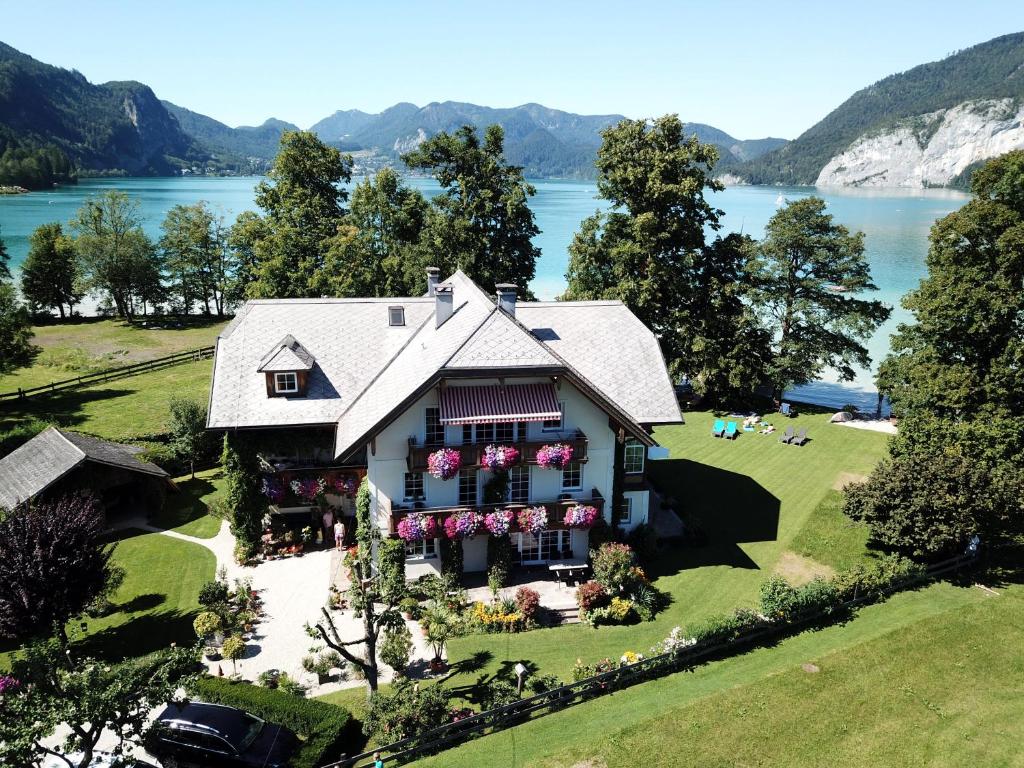 an aerial view of a house with a lake at Landhaus Leitner am Wolfgangsee in Sankt Gilgen
