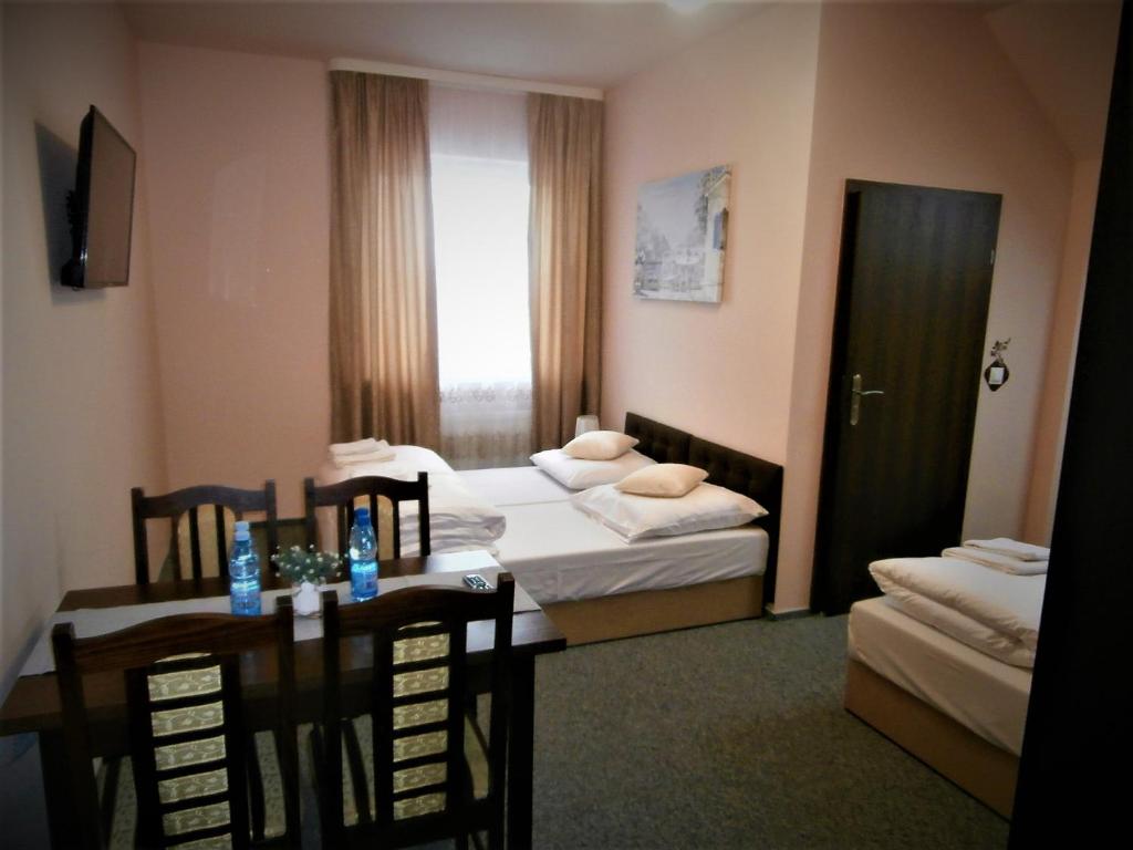 Posteľ alebo postele v izbe v ubytovaní Sum Restauracja & Hotel