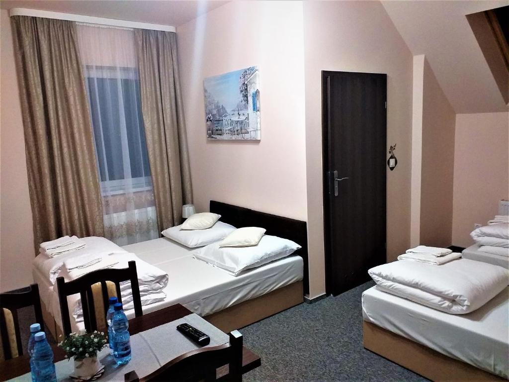 Posteľ alebo postele v izbe v ubytovaní Sum Restauracja & Hotel