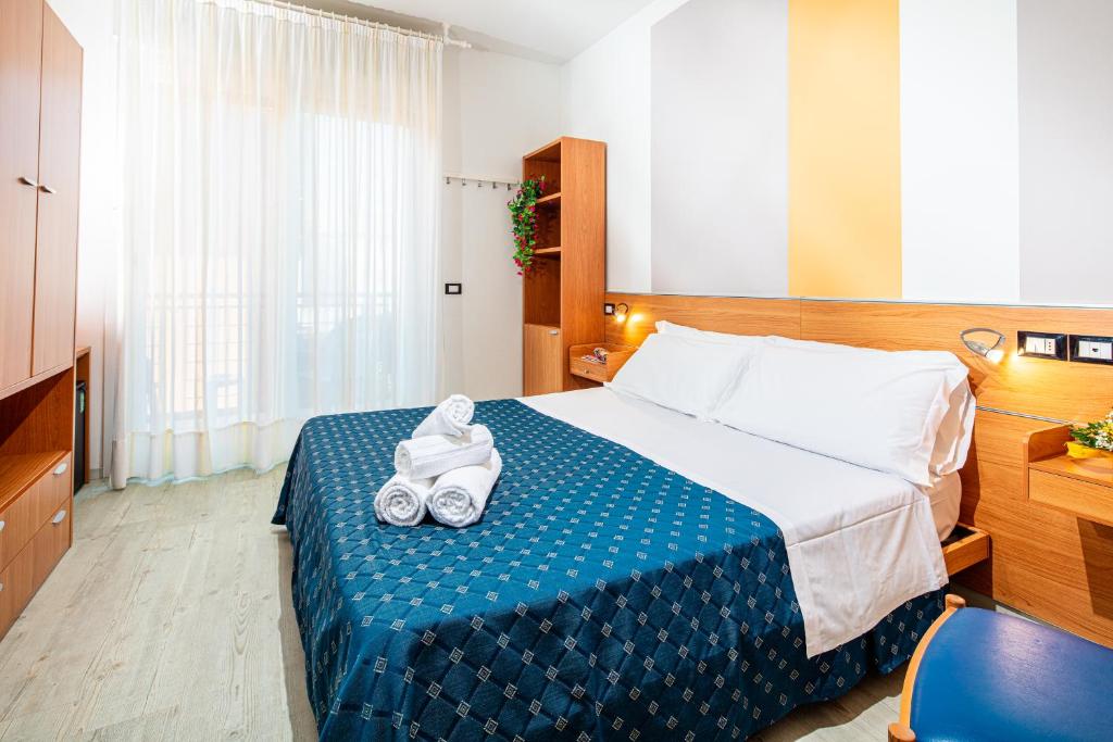 Postel nebo postele na pokoji v ubytování Hotel Orchidea