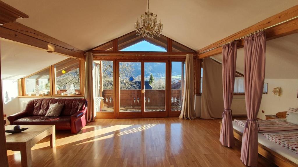 a living room with a couch and a large window at Ossiachersee Apartments in Steindorf am Ossiacher See