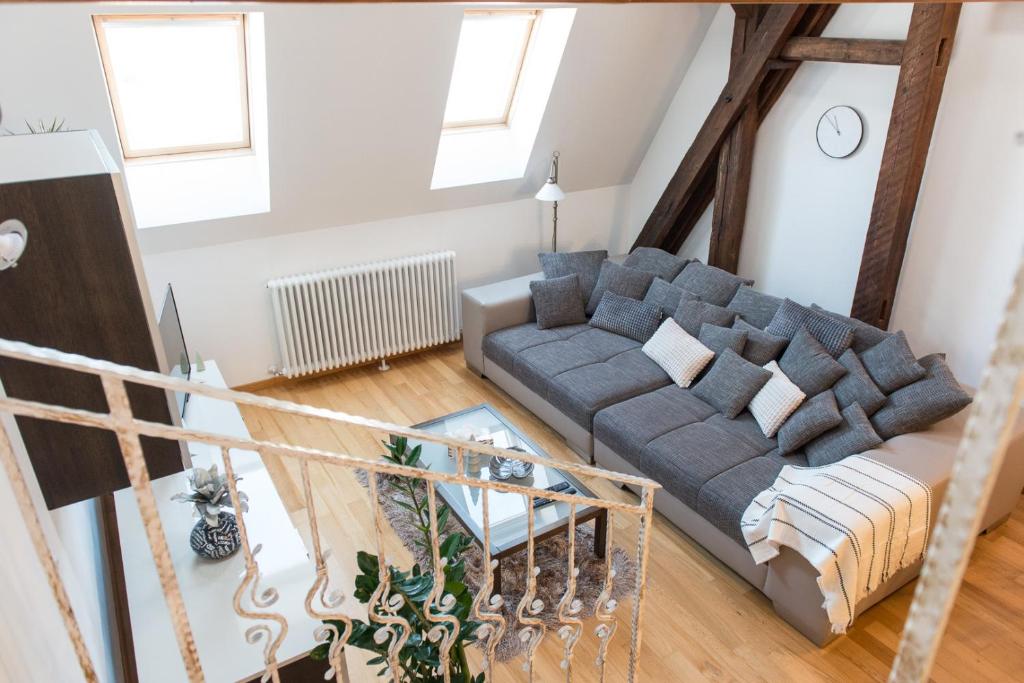 uma sala de estar com um sofá e uma mesa em Comfy loft on Hlavna em Košice