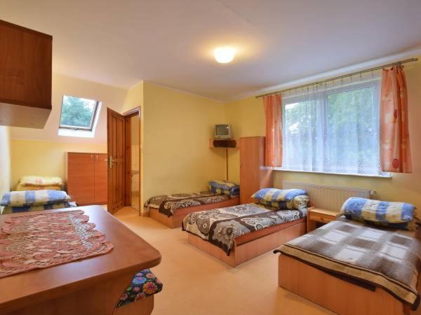 a living room with two beds and a window at NSSM Tanie Spanie in Święta Katarzyna