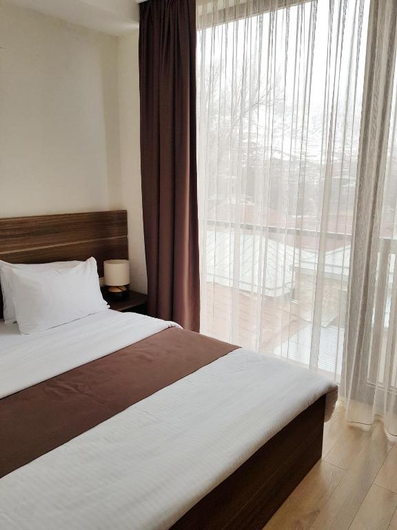 Postel nebo postele na pokoji v ubytování Mount Inn Kazbegi
