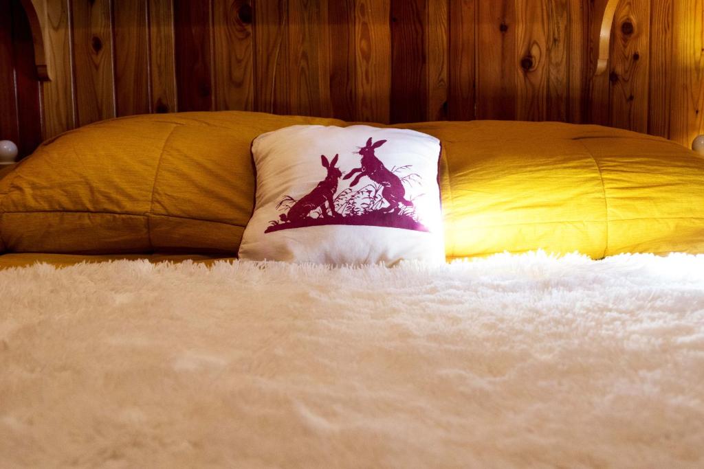 a bed with a pillow with a picture of a giraffe at La tana della lepre in Terminillo