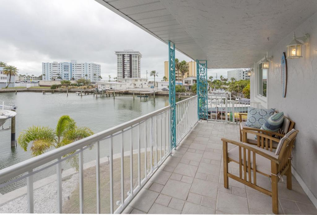 a balcony with a bench and a view of the water at Waterfront & Pool Star5Vacations in St Pete Beach