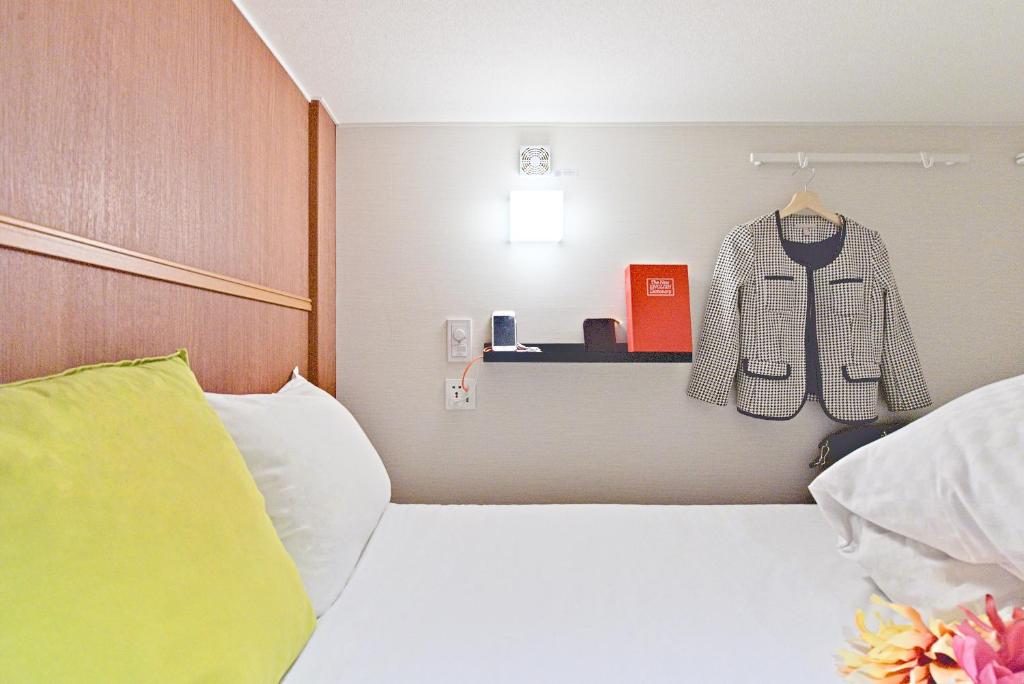 Postel nebo postele na pokoji v ubytování Feel Osaka Yu