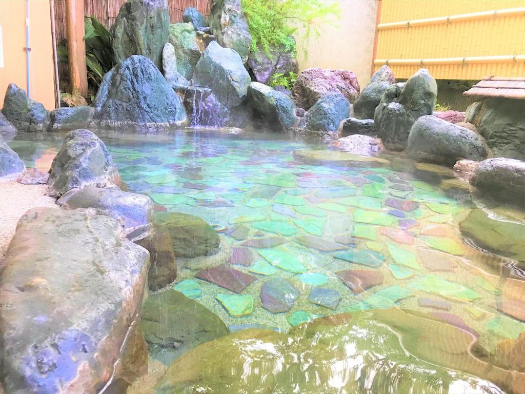 
a pool filled with lots of water and lots of plants at K's House Hostels - Hakone Yumoto Onsen in Hakone
