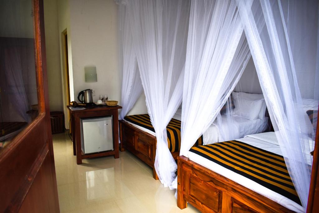 Postel nebo postele na pokoji v ubytování Elegant Home Stay