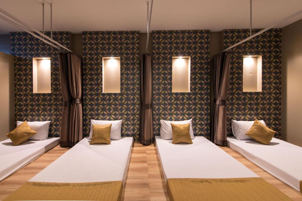 a room with two beds and lights on the wall at River Front Krabi Hotel in Krabi