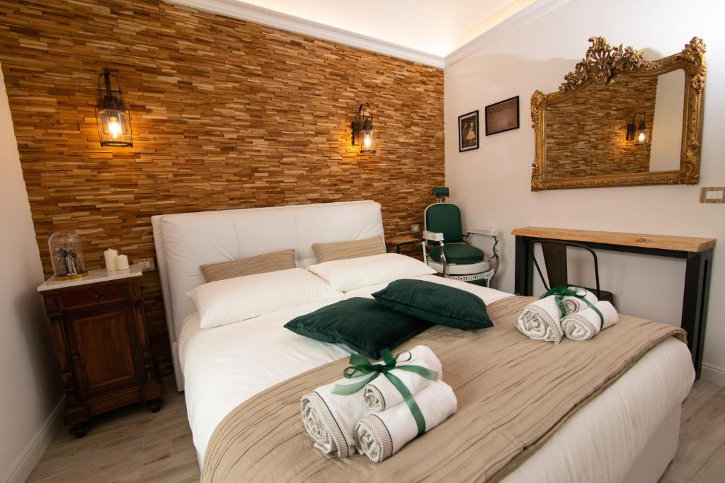 a bedroom with a large white bed with towels on it at La Dimora del Barbiere in Catania