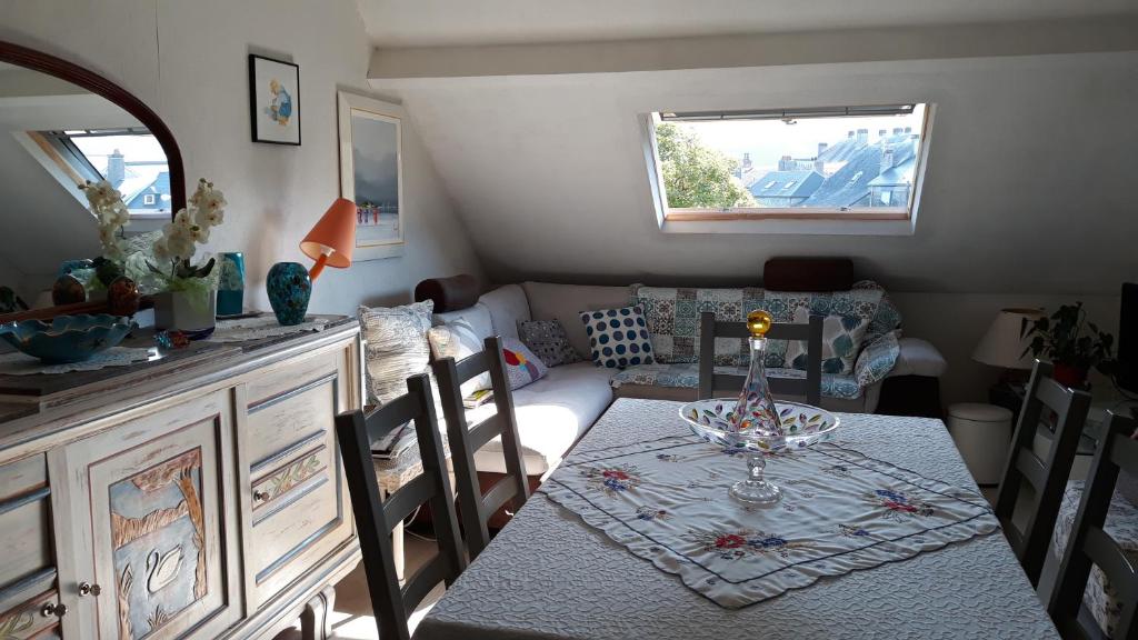 a living room with a table and a couch at Résidence Costallat in Bagnères-de-Bigorre