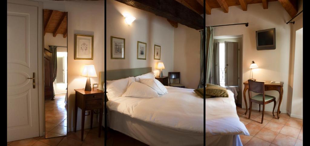 Postel nebo postele na pokoji v ubytování Albergo Orologio