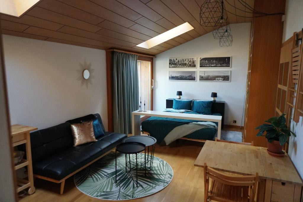 ein Wohnzimmer mit einem Sofa und einem Tisch in der Unterkunft L'Echappée -B&B- in Sion