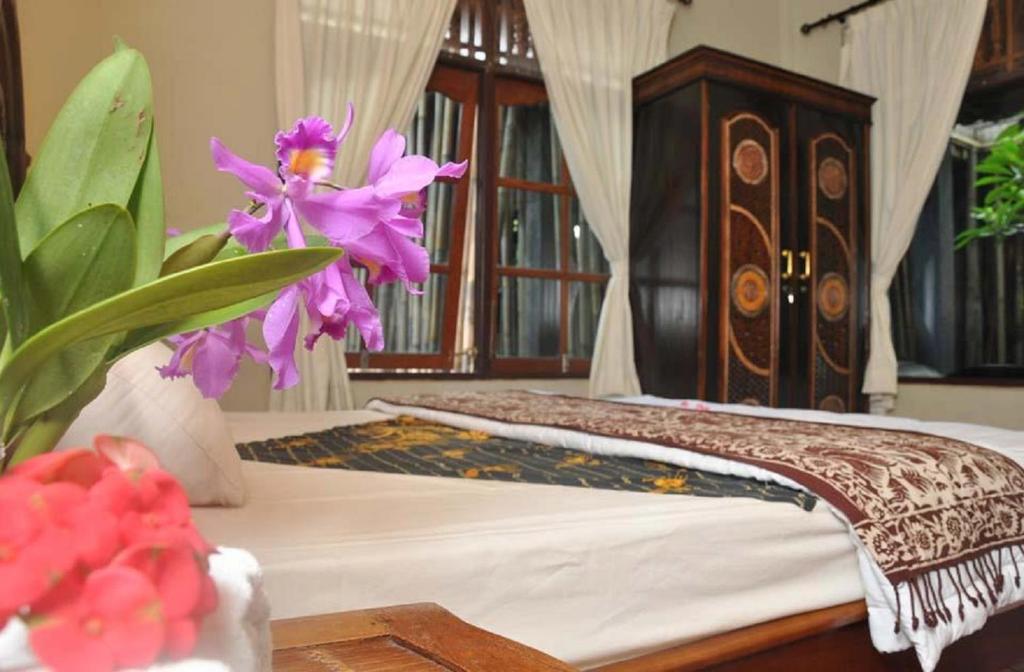 Postel nebo postele na pokoji v ubytování Candra Asri Bungalow