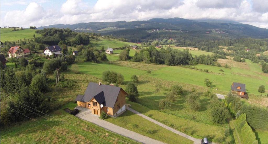 an aerial view of a house in a green field at Villa Dorka in Istebna