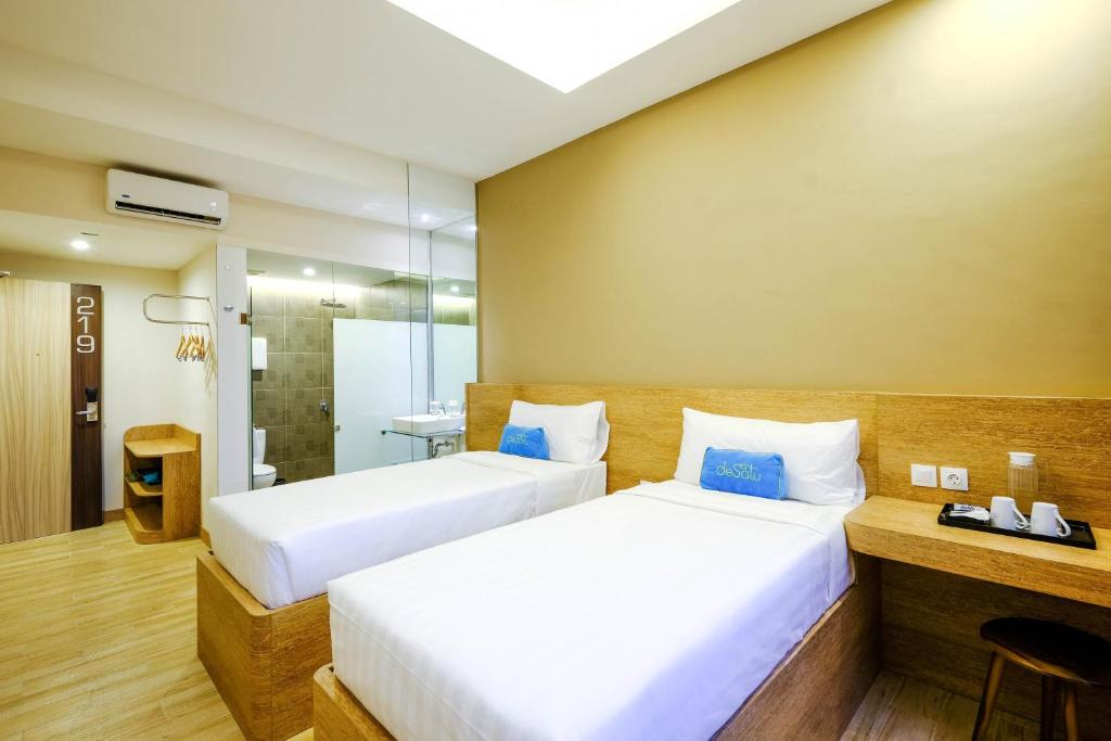 Postel nebo postele na pokoji v ubytování Desatu Hotel