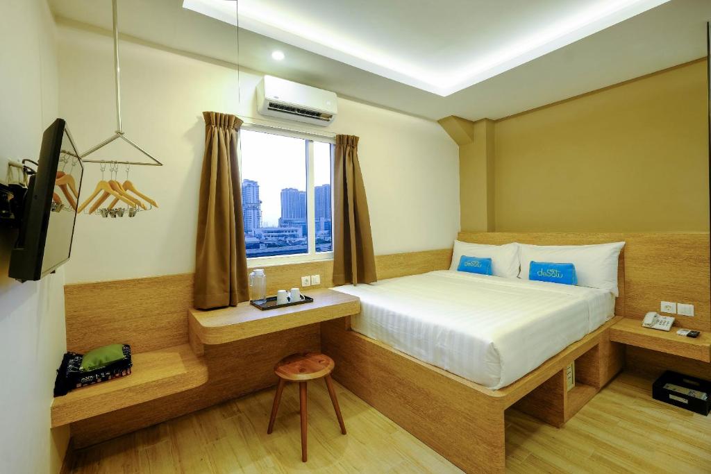 Postel nebo postele na pokoji v ubytování Desatu Hotel