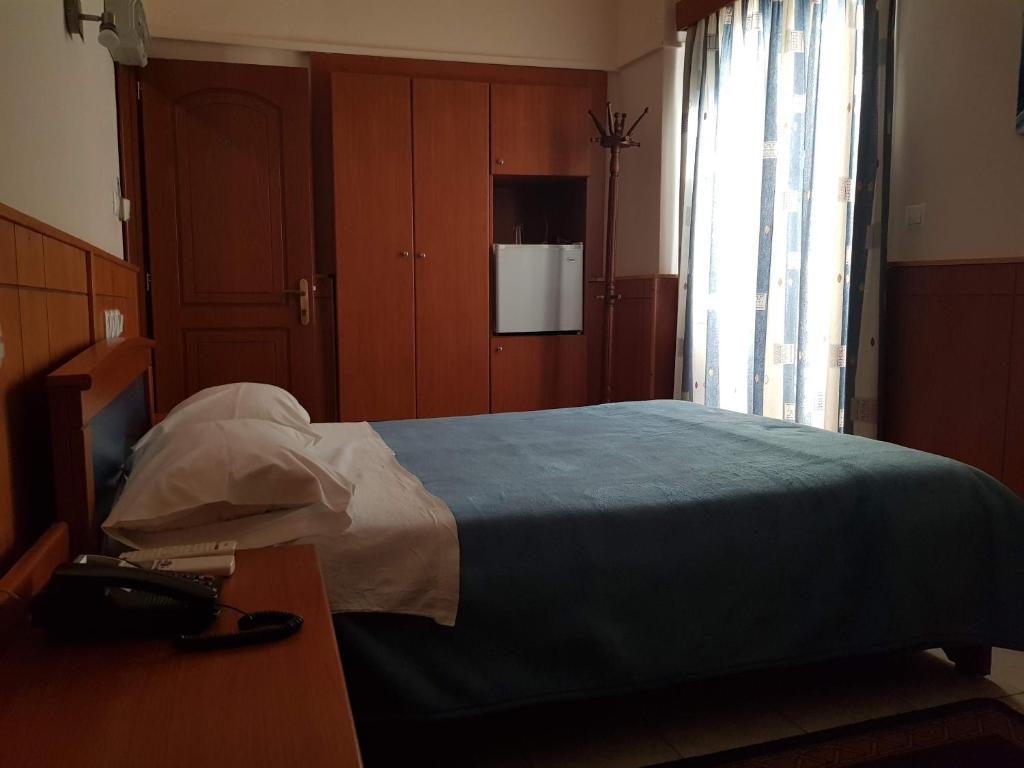 Łóżko lub łóżka w pokoju w obiekcie Hotel Ionion