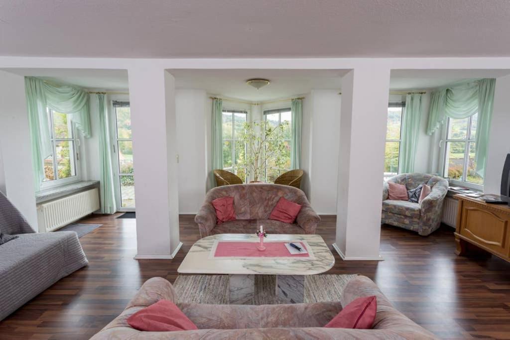 a living room with a couch and a coffee table at Schöne Ferienwohnung am Schlosspark in Bad Brückenau