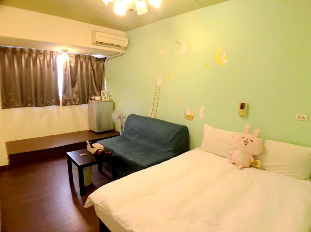 a hospital room with a bed and a chair at Happines Trip Inn in Taichung