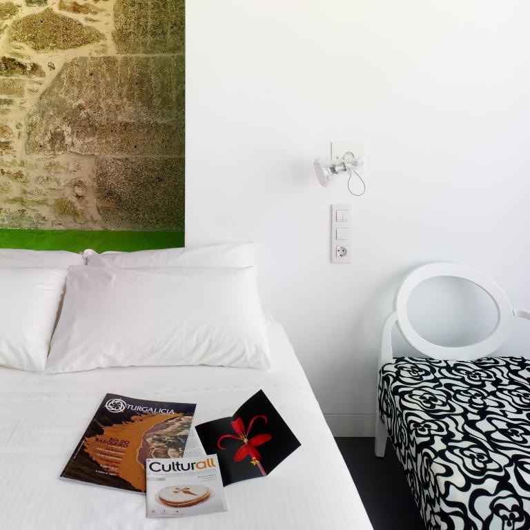 Postel nebo postele na pokoji v ubytování Moure Hotel