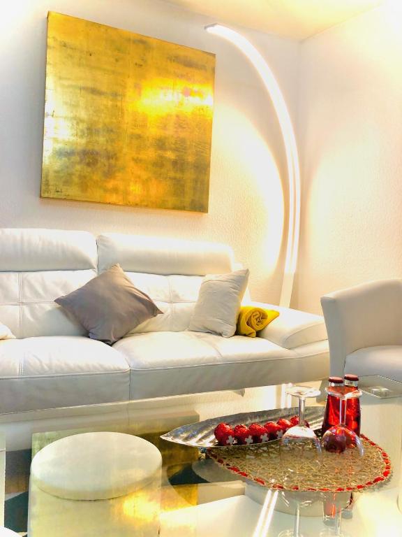 a living room with a white couch and a table at Lake & Mountain View Apartment I 27 in Montreux