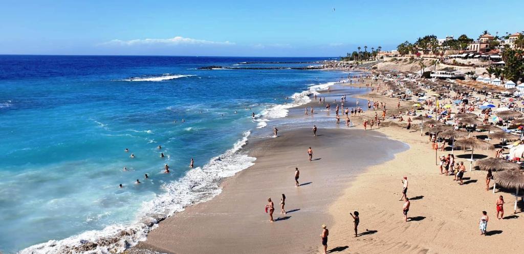 a group of people on a beach near the ocean at Feel-good-oasis in Playa Paraiso