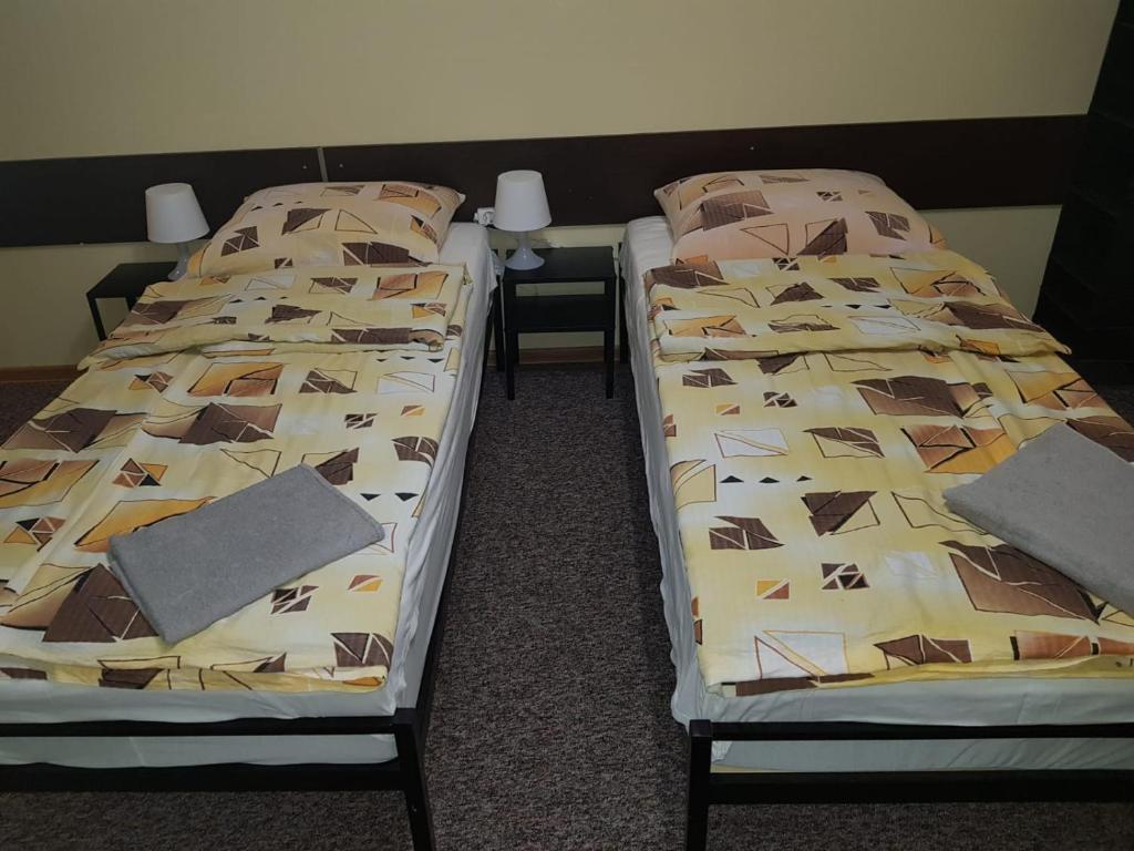 two beds sitting next to each other in a room at Pokoje Relaks 2 in Gdynia