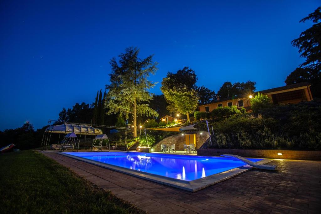 a swimming pool in a yard at night at Villa-Alta in Imola