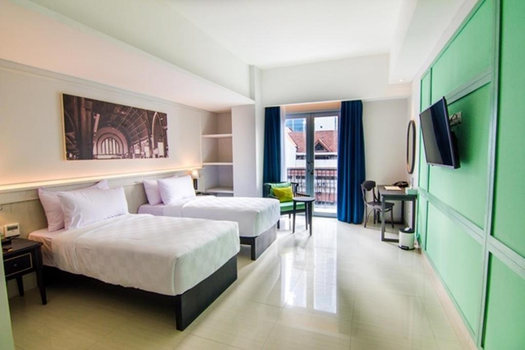 Postel nebo postele na pokoji v ubytování Jambuluwuk Thamrin Hotel