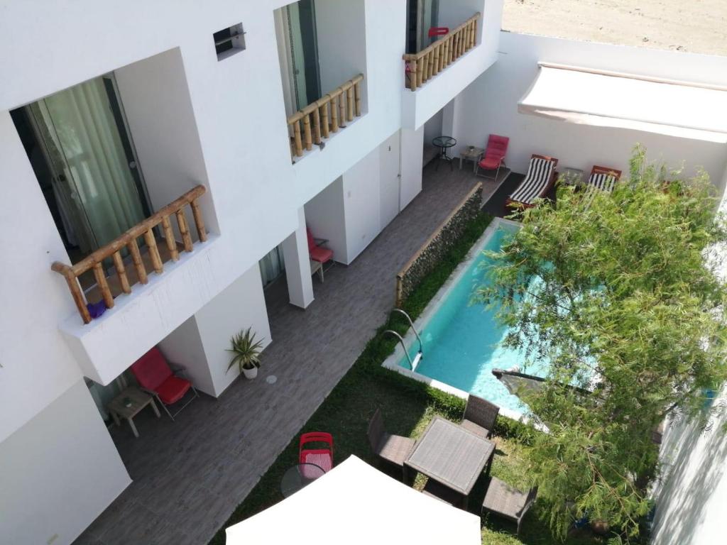 an aerial view of a building with a swimming pool at Paracas Guest House in Paracas