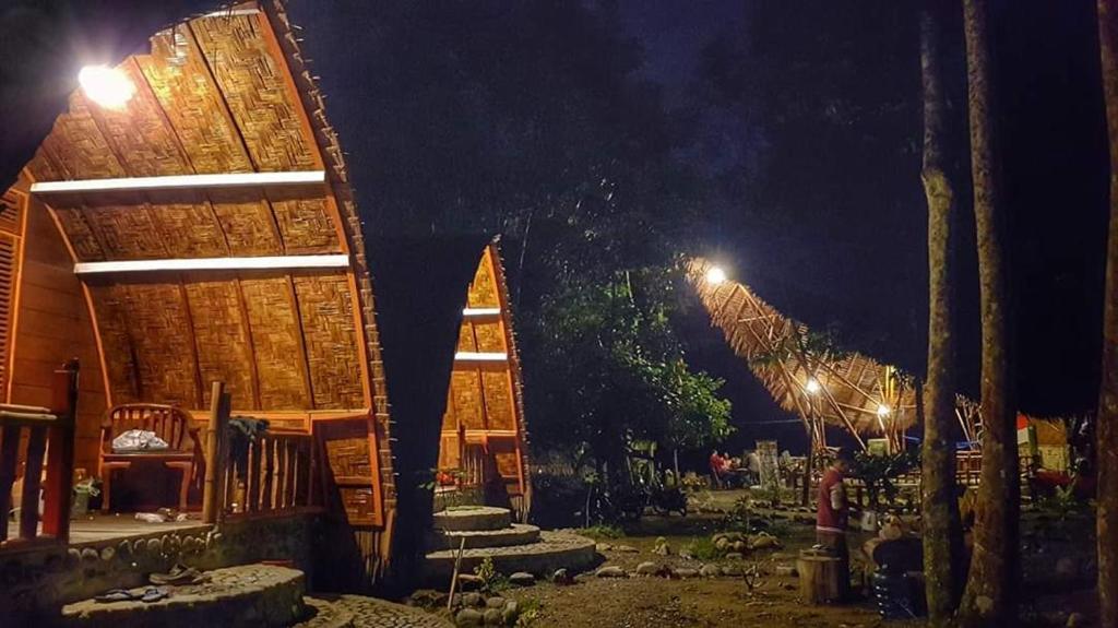 a group of buildings with lights at night at ETALAUSER Jungle Gate EcoResort Bukit Lawang in Bukit Lawang