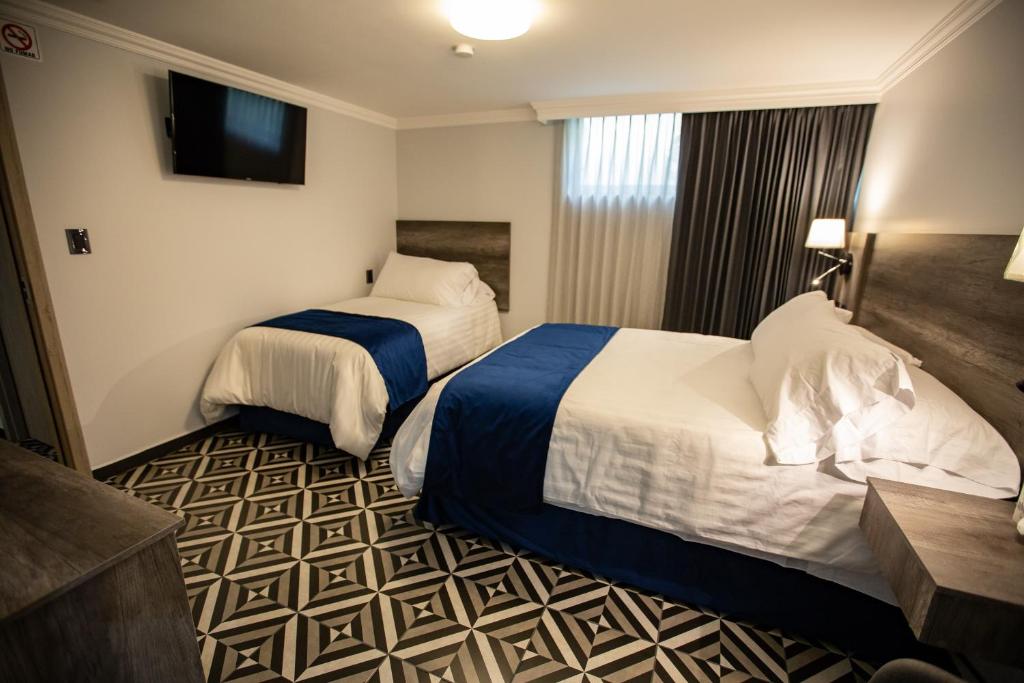 Postel nebo postele na pokoji v ubytování Hotel Esfera Tulancingo