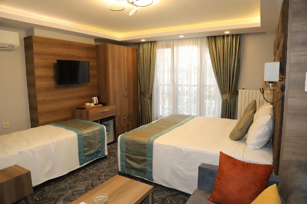 Postel nebo postele na pokoji v ubytování Grand Kavi Hotel