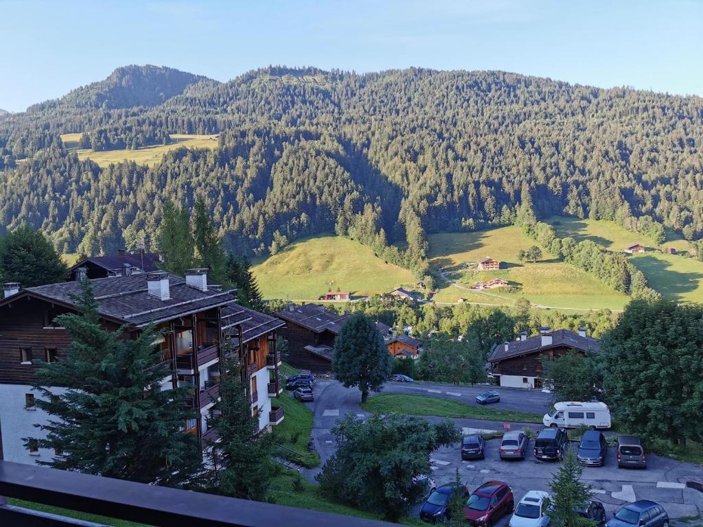 a view of a mountain with cars parked in a parking lot at Studio le Grand-Bornand Village in Le Grand-Bornand