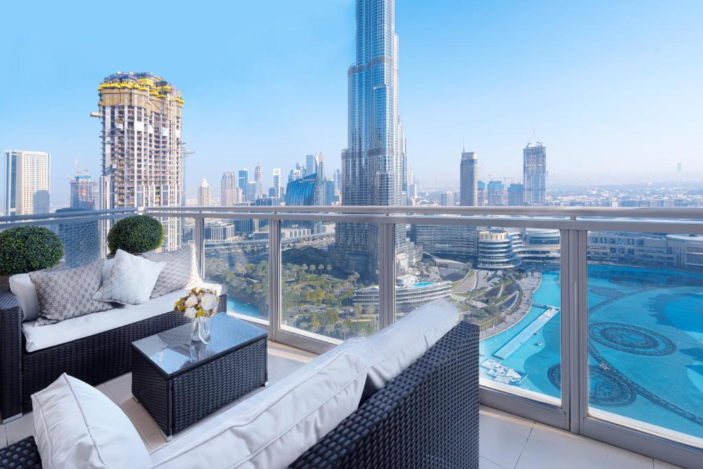 a balcony with couches and a view of a city at Elite Royal Apartment - Full Burj Khalifa & Fountain View - Royal in Dubai