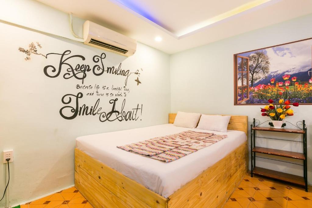 a bedroom with a bed with a sign on the wall at Ben Thanh Dorm in Ho Chi Minh City