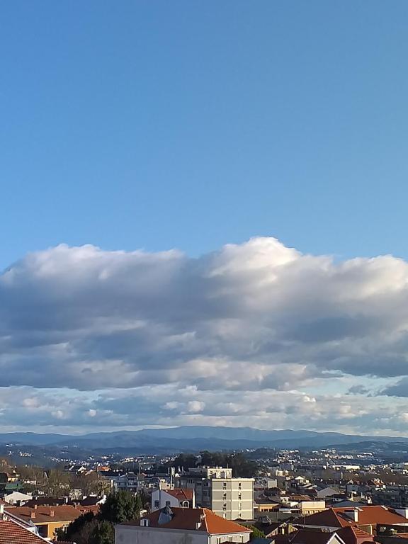 a view of a city under a cloudy sky at Studio Downtown Oporto in Porto