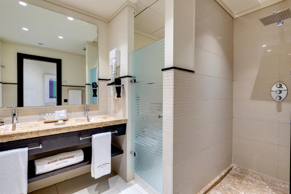 a bathroom with a shower and a sink at Royal Hideaway Sancti Petri in Chiclana de la Frontera