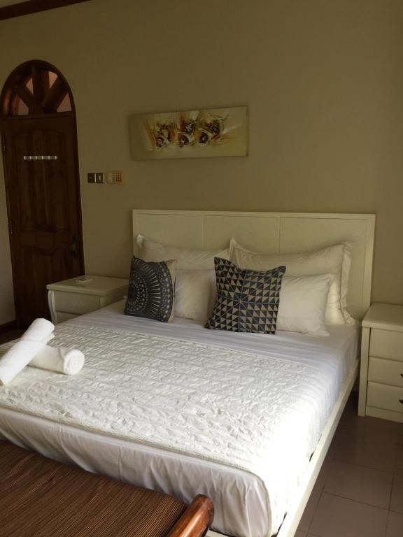 Postel nebo postele na pokoji v ubytování Bayview Villas Seychelles
