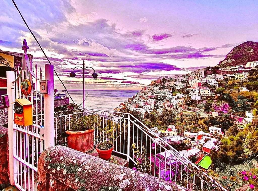 a view of a city from a balcony with flowers at Villa Stella del mare in Positano