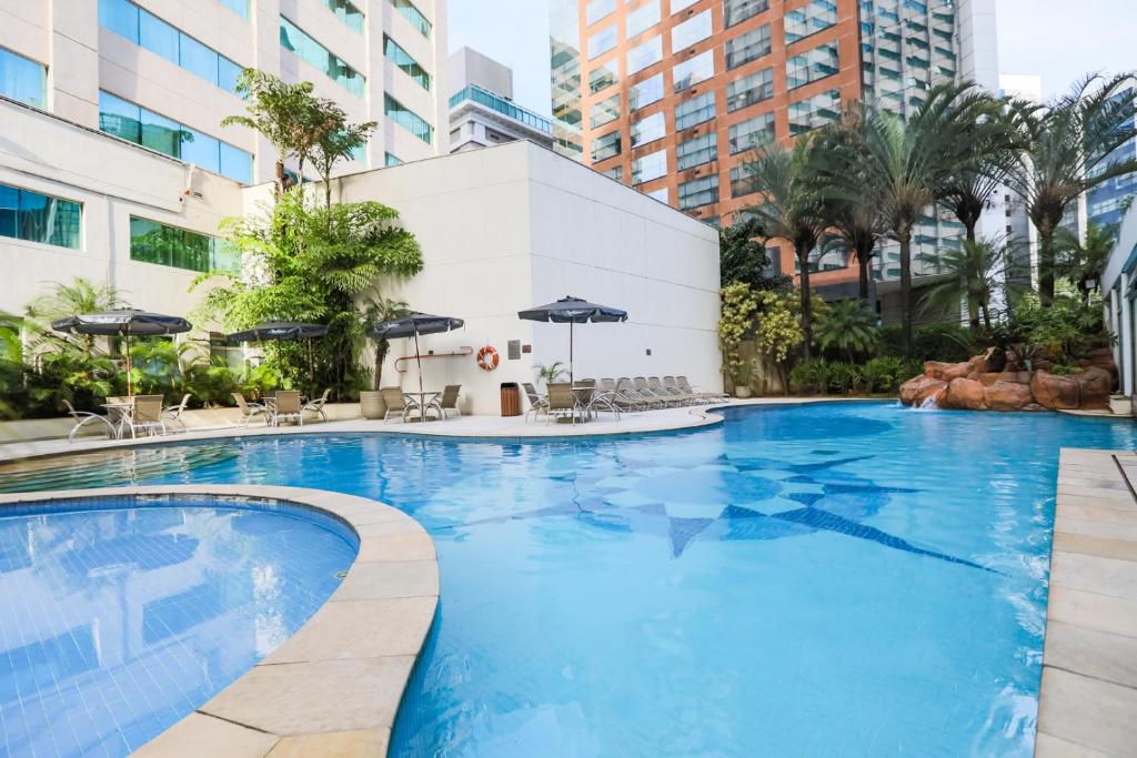 a large swimming pool in the middle of a building at Radisson Vila Olimpia Sao Paulo in Sao Paulo