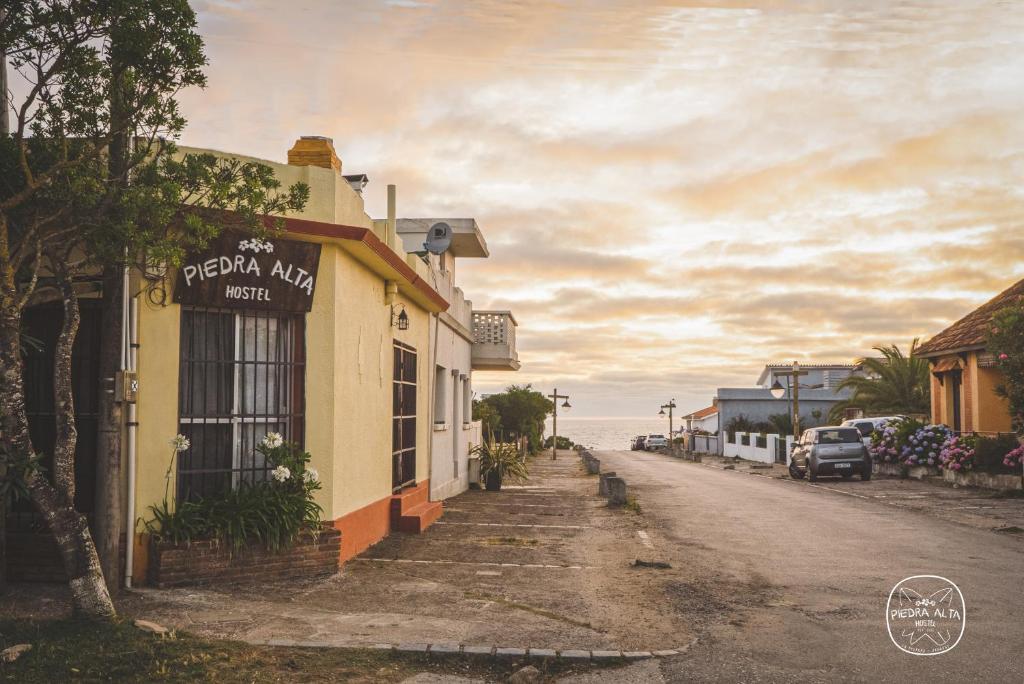 an empty street in a town with a building at Piedra Alta Hostel & Suites in La Pedrera