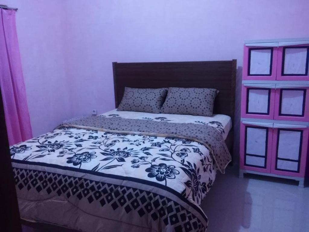 Postel nebo postele na pokoji v ubytování Wildan Homestay