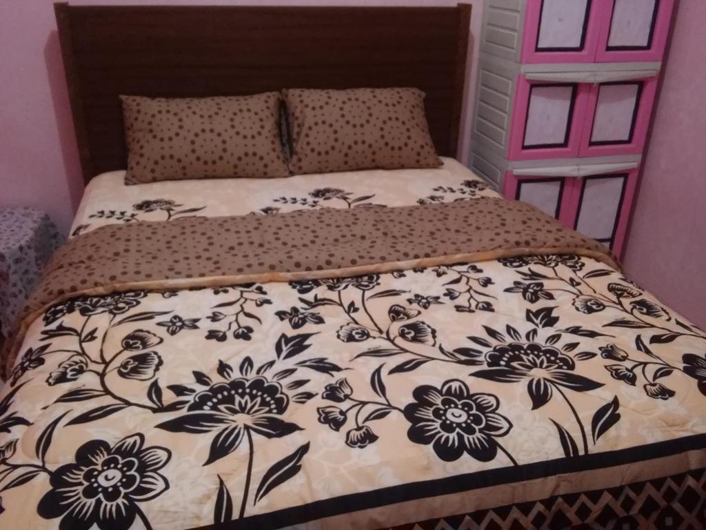 Postel nebo postele na pokoji v ubytování Wildan Homestay