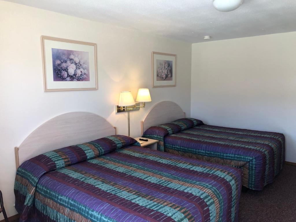 Postel nebo postele na pokoji v ubytování Wheels Motel